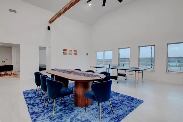 a dining room with a table and chairs