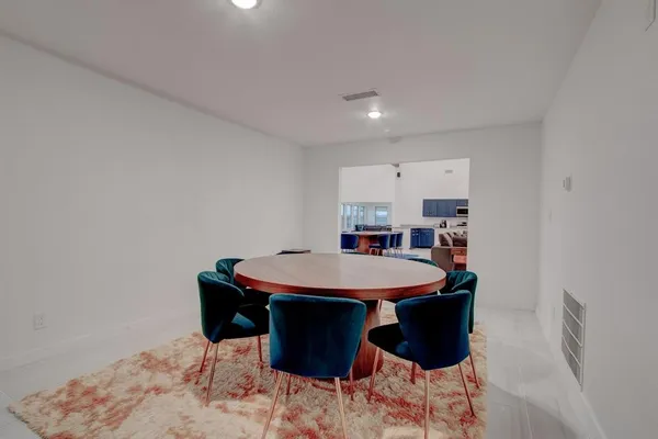 a kitchen with kitchen island a sink refrigerator and microwave