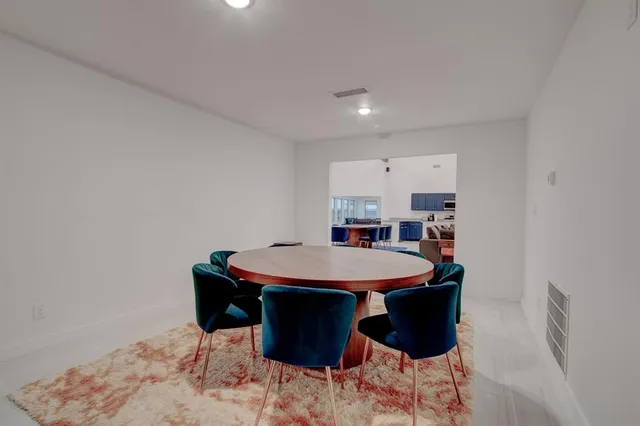 a kitchen with kitchen island a sink refrigerator and microwave