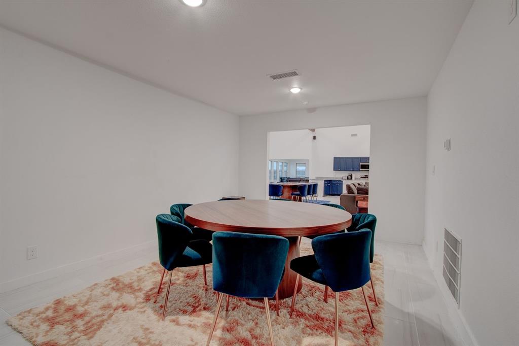 550 County Road 297 Gainesville, TX 76240 - Photo 6 of 24 a dining room with a table and chairs