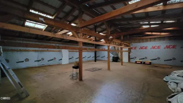 a view of empty room with wooden ceiling