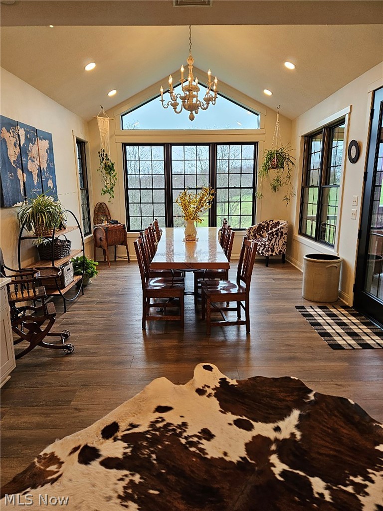 25073 Ridge Road East Rochester, OH 44625 - Photo 22 of 37 Dining room featuring an inviting chandelier, dark hardwood / wood-style flooring, and lofted ceiling