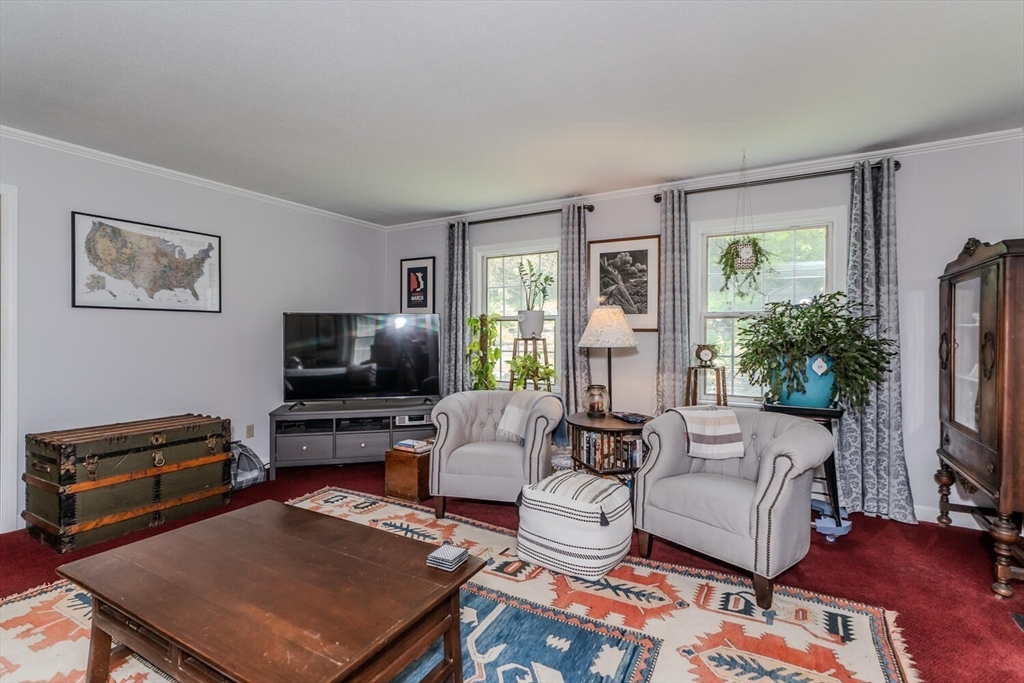 87 Montague Road Westhampton, MA 01027 - Photo 11 of 42 a living room with furniture a flat screen tv and a fireplace