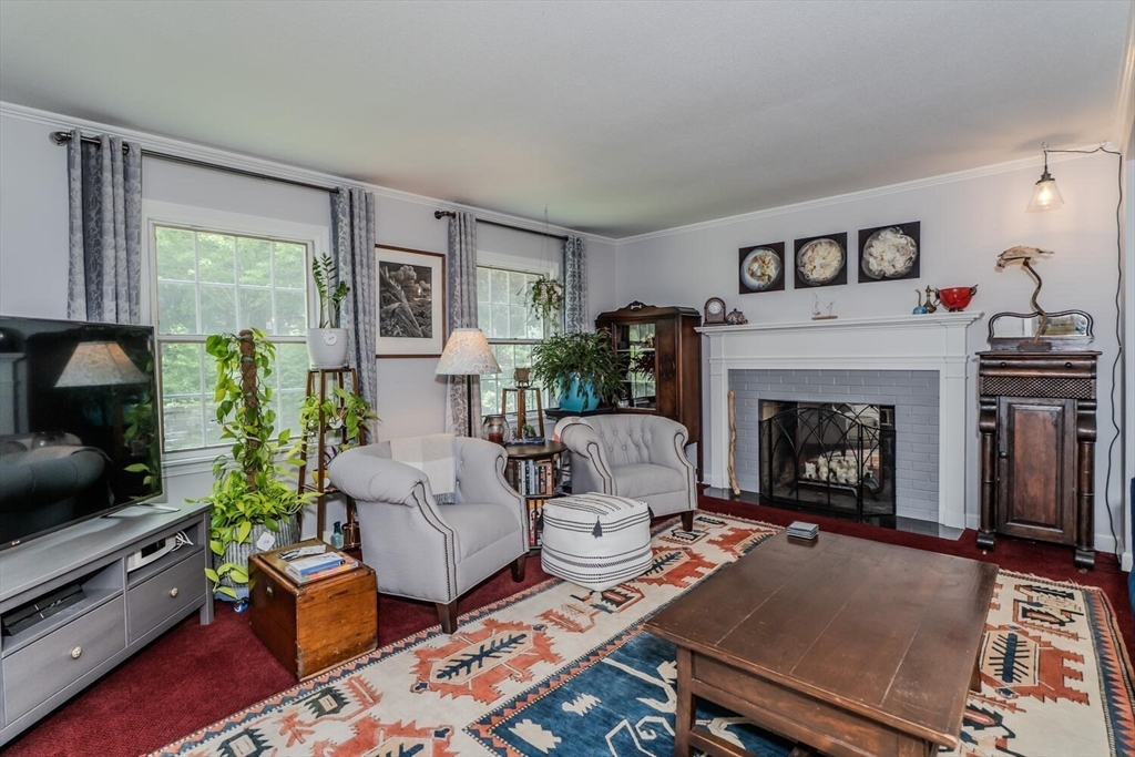 87 Montague Road Westhampton, MA 01027 - Photo 13 of 42 a living room with furniture a flat screen tv and a fireplace