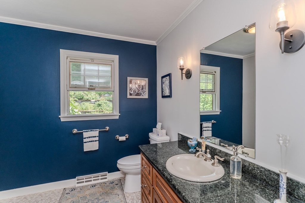 87 Montague Road Westhampton, MA 01027 - Photo 18 of 42 a bathroom with a granite countertop sink toilet and mirror