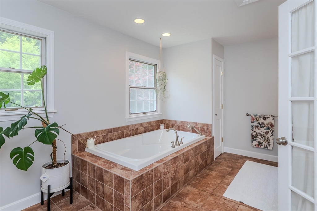 87 Montague Road Westhampton, MA 01027 - Photo 24 of 42 a white bath tub sitting in a bathroom next to a window