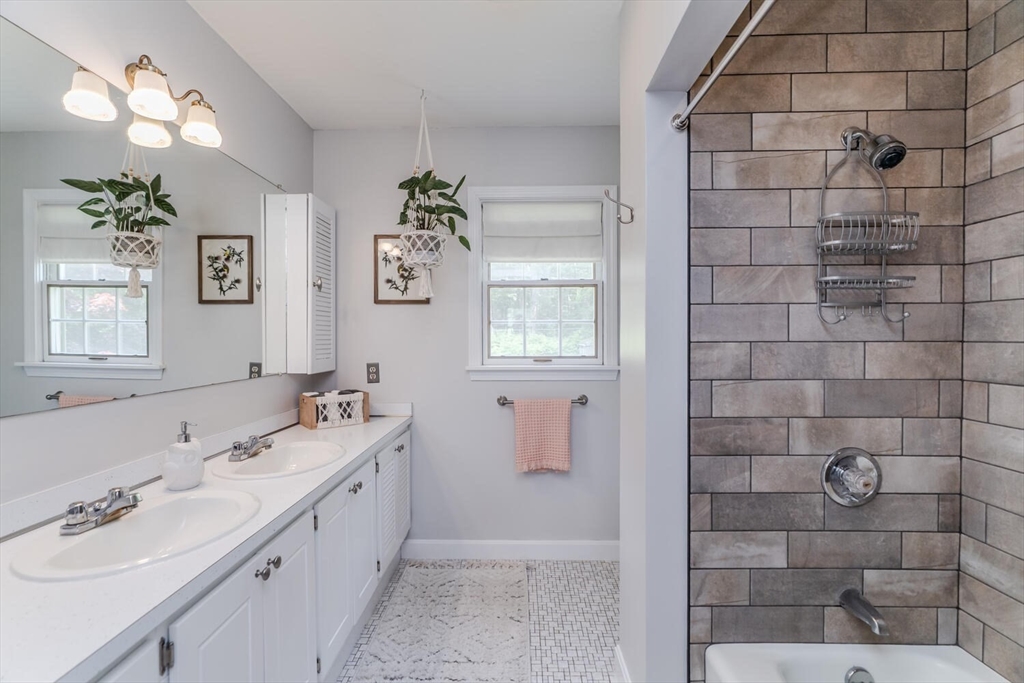 87 Montague Road Westhampton, MA 01027 - Photo 29 of 42 a bathroom with a double vanity sink mirror and shower