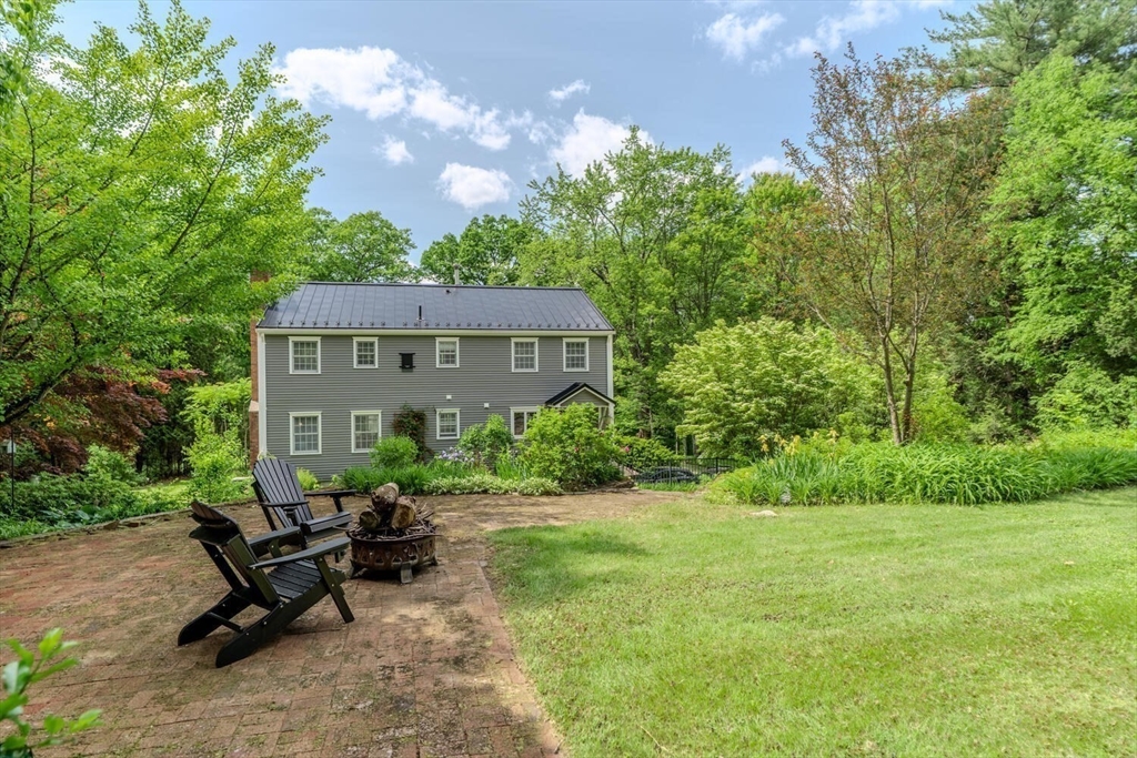 87 Montague Road Westhampton, MA 01027 - Photo 33 of 42 a view of a patio with table and chairs and potted plants with large tree