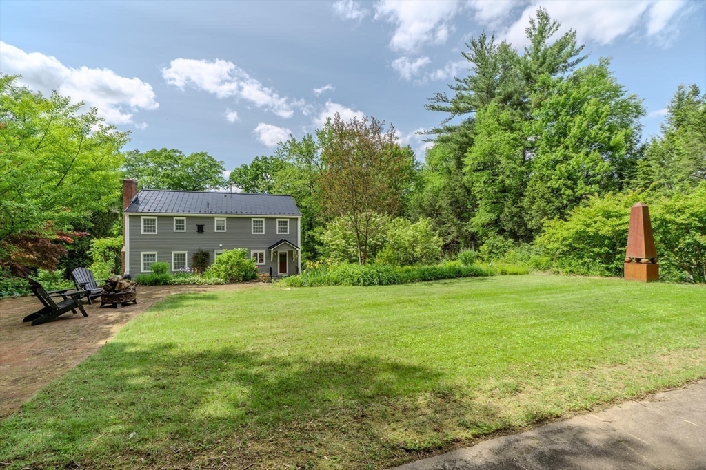 87 Montague Road Westhampton, MA 01027 - Photo 37 of 42 a view of a big house with a big yard and large trees