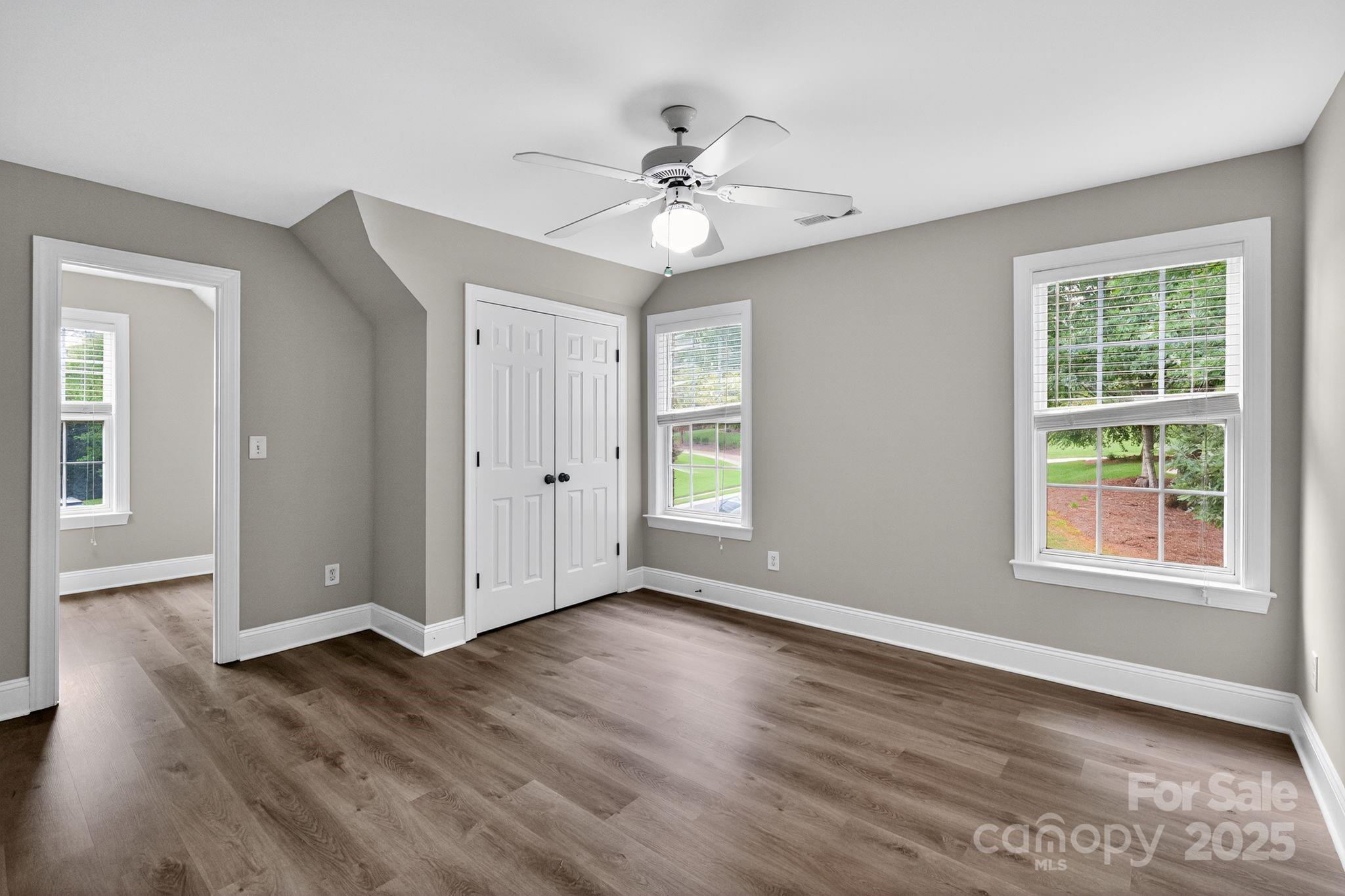 1000 Potters Bluff Road Monroe, NC 28110 - Photo 11 of 20 a view of an empty room with wooden floor and a window
