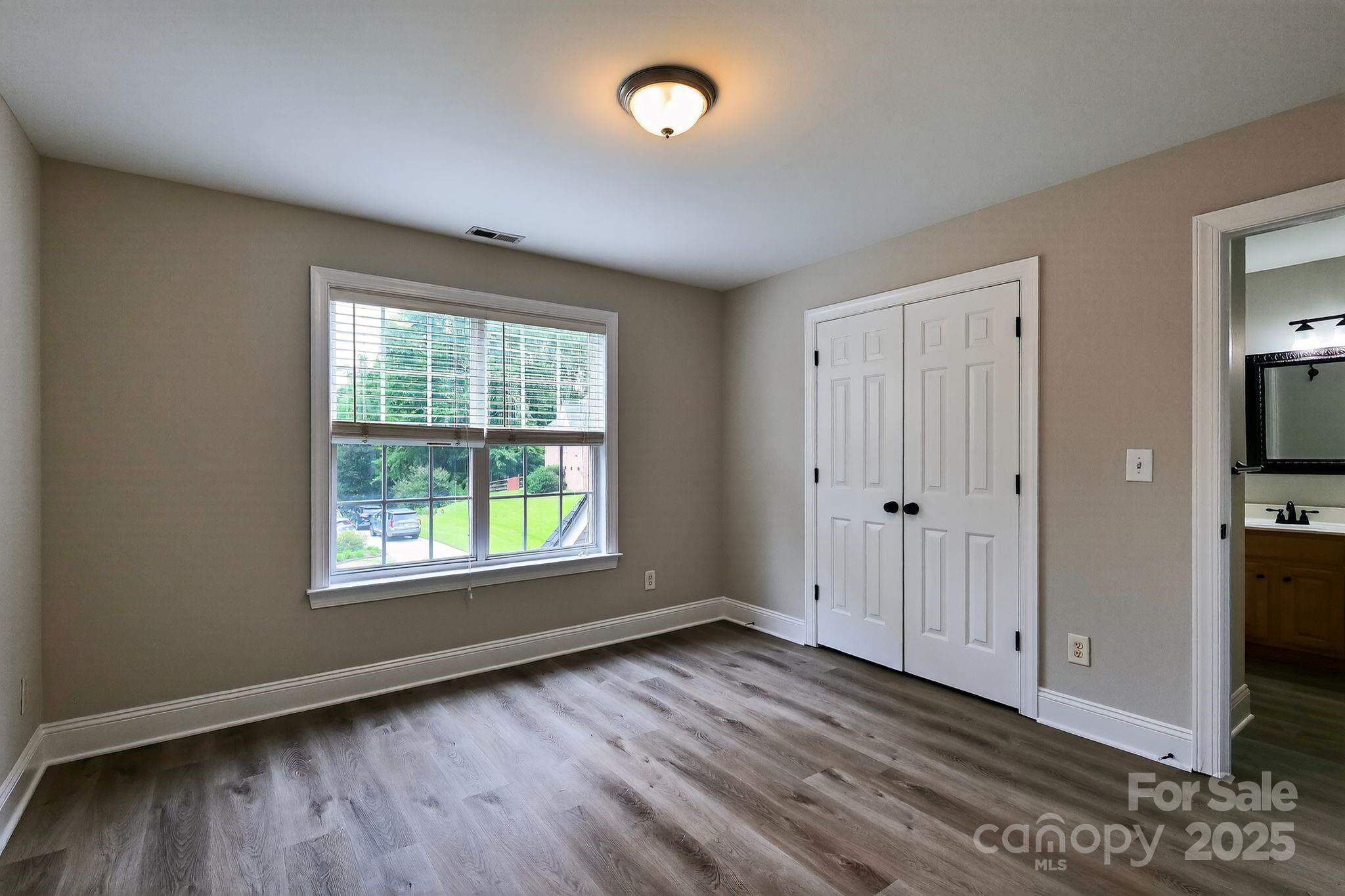 1000 Potters Bluff Road Monroe, NC 28110 - Photo 14 of 20 a view of an empty room with wooden floor and a window