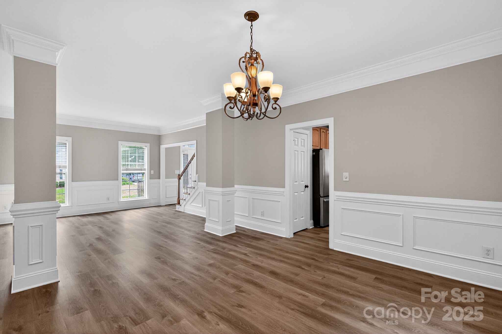 1000 Potters Bluff Road Monroe, NC 28110 - Photo 3 of 20 a view of empty room with wooden floor and fan