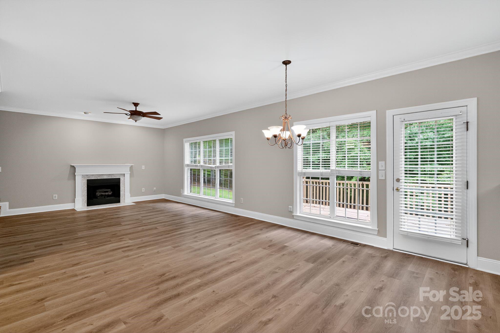 1000 Potters Bluff Road Monroe, NC 28110 - Photo 4 of 20 a view of an empty room with wooden floor and a window