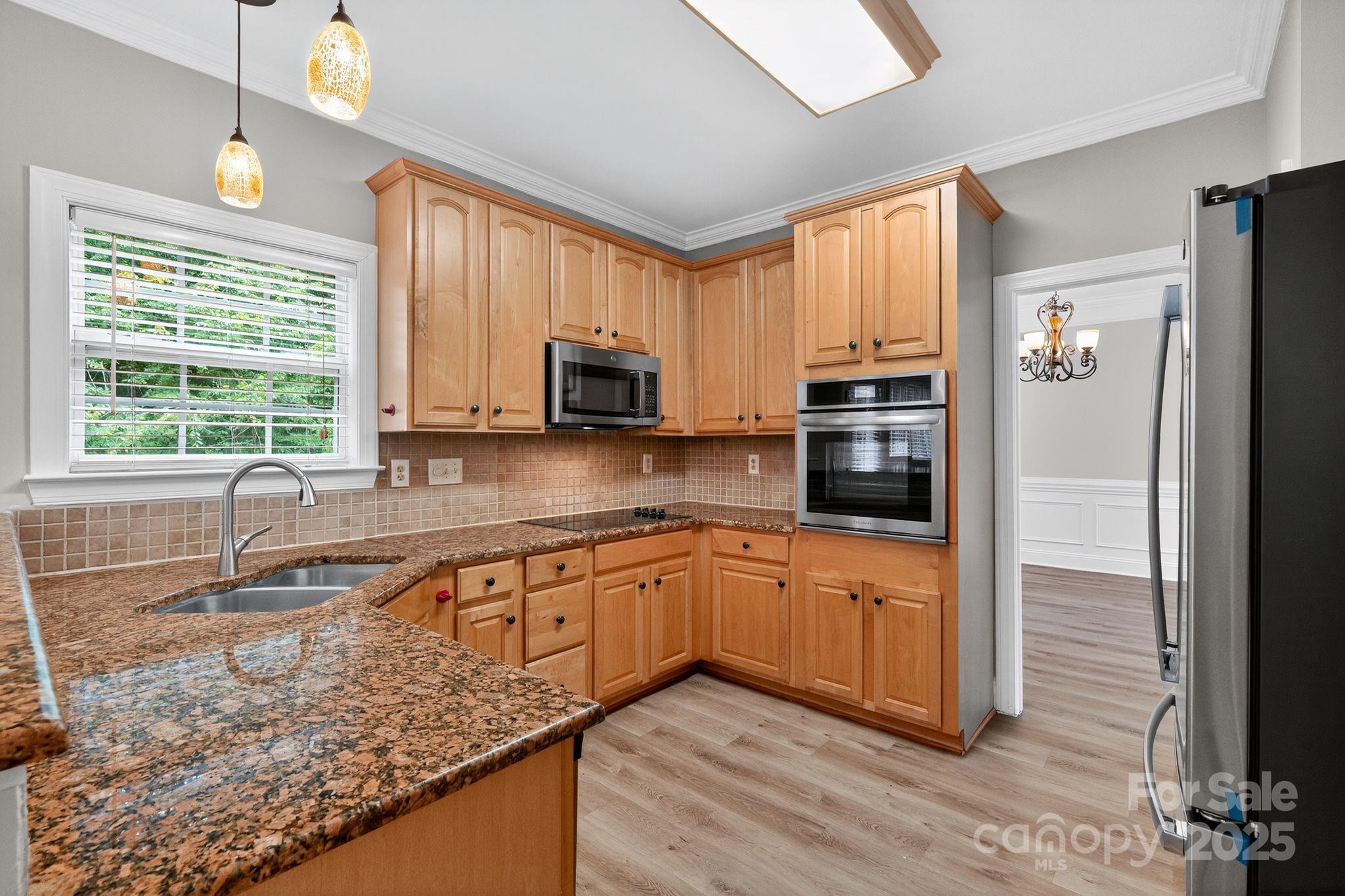 1000 Potters Bluff Road Monroe, NC 28110 - Photo 5 of 20 a kitchen with stainless steel appliances granite countertop a stove a sink and a microwave