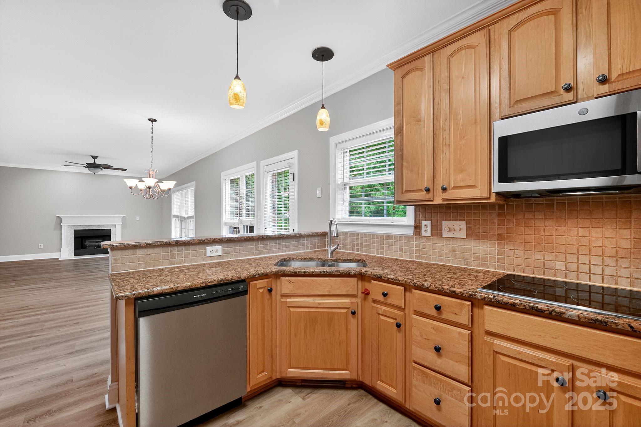 1000 Potters Bluff Road Monroe, NC 28110 - Photo 6 of 20 a kitchen with granite countertop a sink a stove and microwave