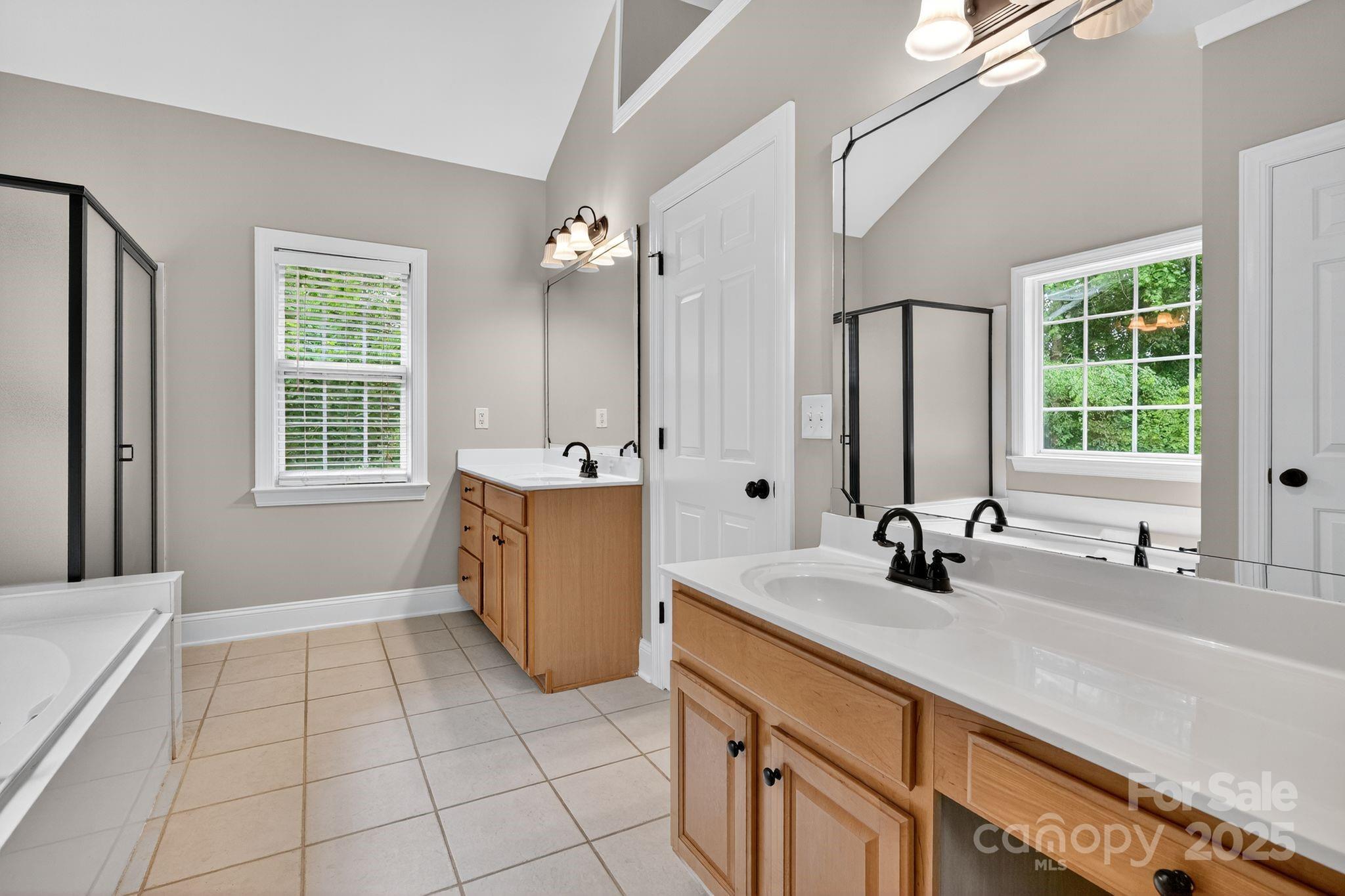 1000 Potters Bluff Road Monroe, NC 28110 - Photo 9 of 20 a bathroom with a sink double vanity and a bathtub