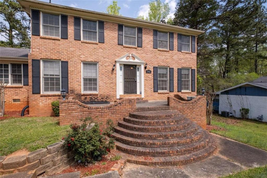 3952 Veracruz Drive Decatur, GA 30034 - Photo 1 of 1 a front view of a house with a yard and outdoor seating