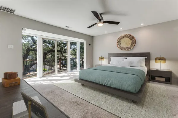 a bedroom with a large bed and a large window