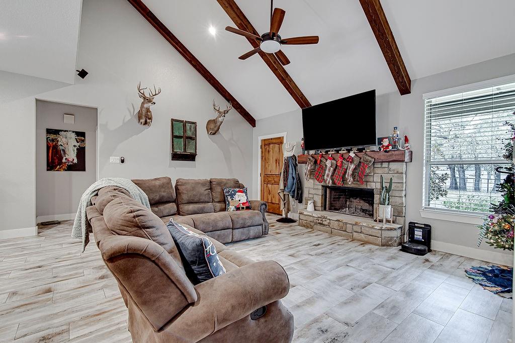 3817 Cross Timber Road Burleson, TX 76028 - Photo 19 of 36 a living room with furniture a flat screen tv and a fireplace