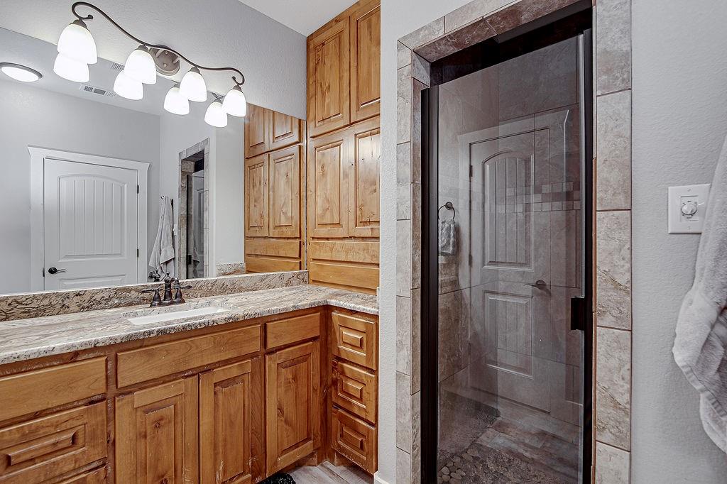 3817 Cross Timber Road Burleson, TX 76028 - Photo 25 of 36 a bathroom with a granite countertop sink and a mirror