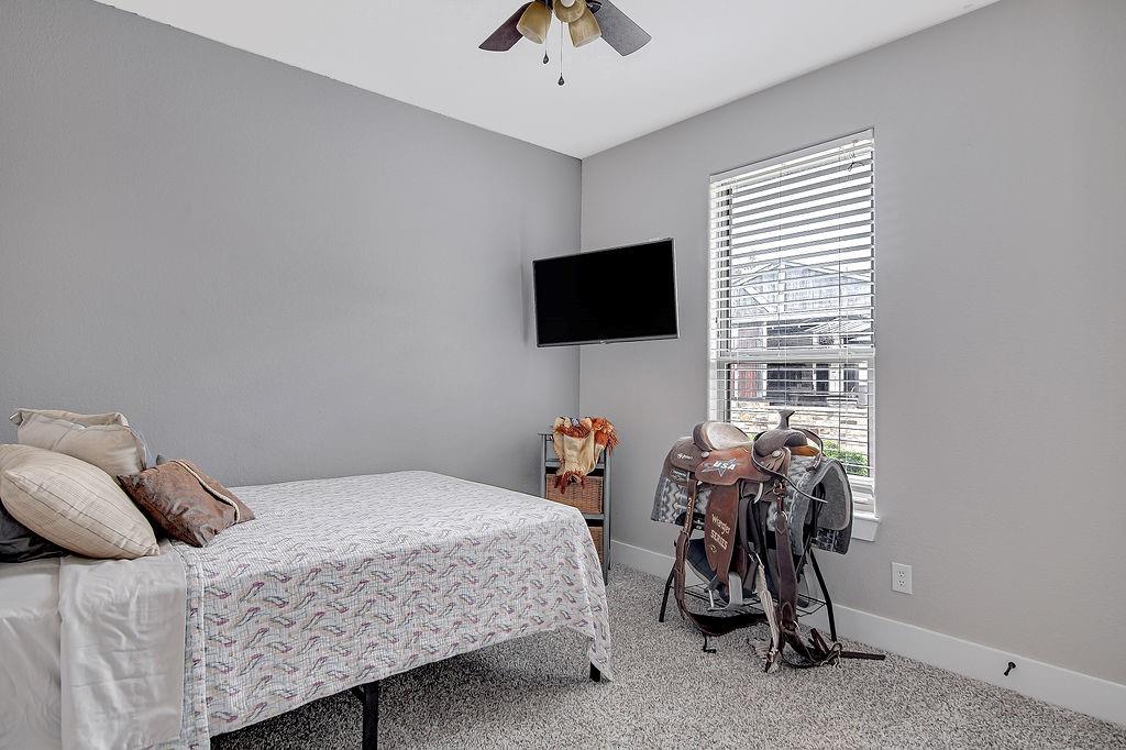 3817 Cross Timber Road Burleson, TX 76028 - Photo 27 of 36 a bedroom with a bed and a flat screen tv