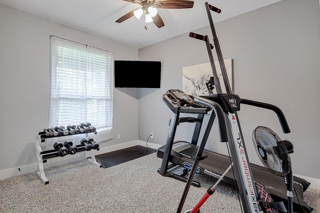 3817 Cross Timber Road Burleson, TX 76028 - Photo 29 of 36 a room with gym equipment and windows
