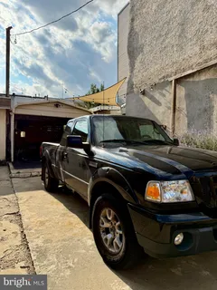 a car parked in front of a brick building