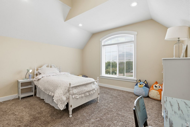 672 Perry Hollow Drive Mapleton, UT 84664 - Photo 52 of 106 Bedroom featuring an arched window, recessed lighting, vaulted ceiling, and neutral-toned carpeting