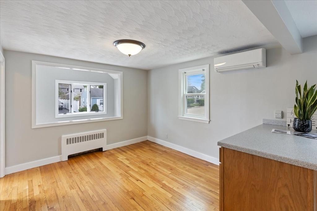 7 G Street Hull, MA 02045 - Photo 11 of 34 a view of an empty room with wooden floor and a window
