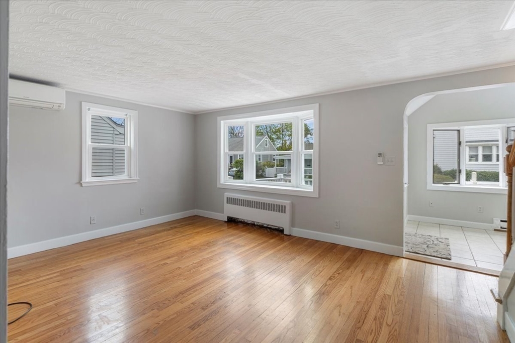 7 G Street Hull, MA 02045 - Photo 15 of 34 a view of an empty room with wooden floor and a window