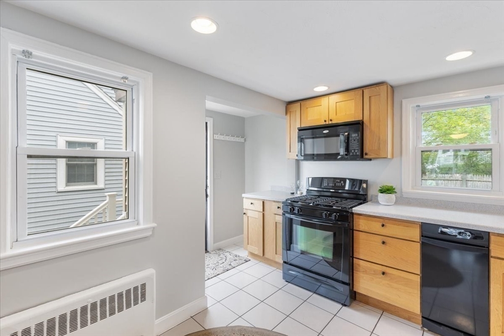 7 G Street Hull, MA 02045 - Photo 17 of 34 a kitchen with a stove a sink and a microwave