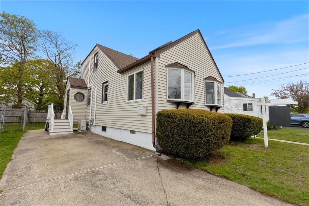 7 G Street Hull, MA 02045 - Photo 2 of 34 a front view of a house with a garden