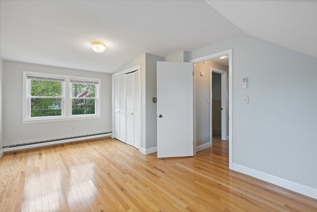 7 G Street Hull, MA 02045 - Photo 30 of 34 an empty room with wooden floor and windows