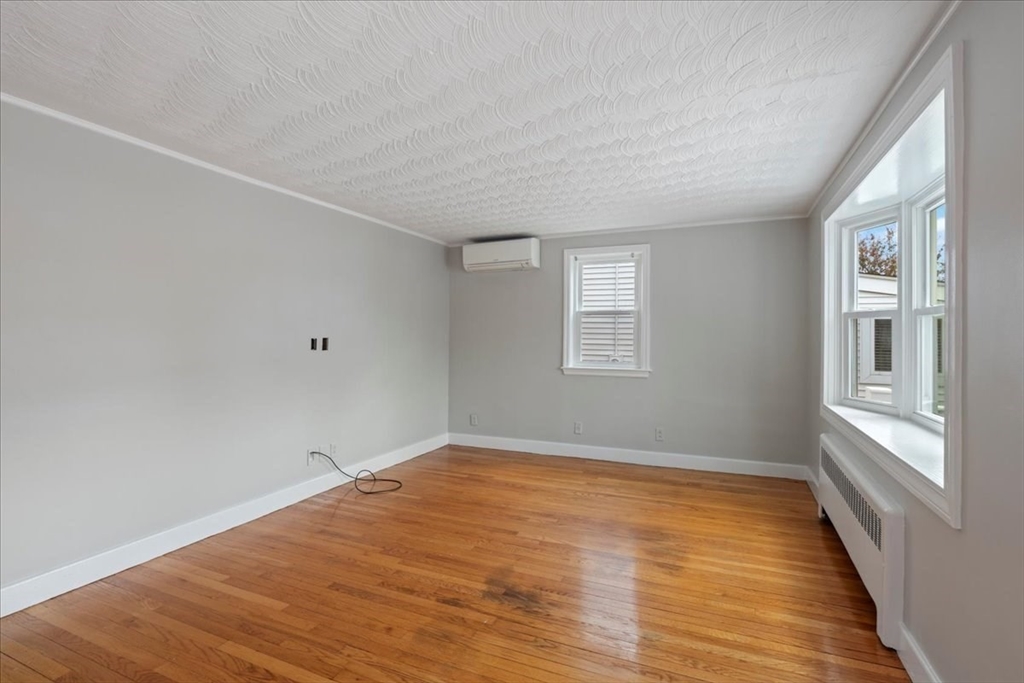 7 G Street Hull, MA 02045 - Photo 31 of 34 a view of an empty room with wooden floor and a window