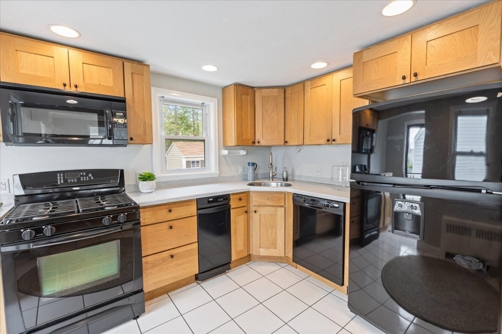 7 G Street Hull, MA 02045 - Photo 10 of 34 a kitchen with stainless steel appliances granite countertop a stove a sink and a microwave