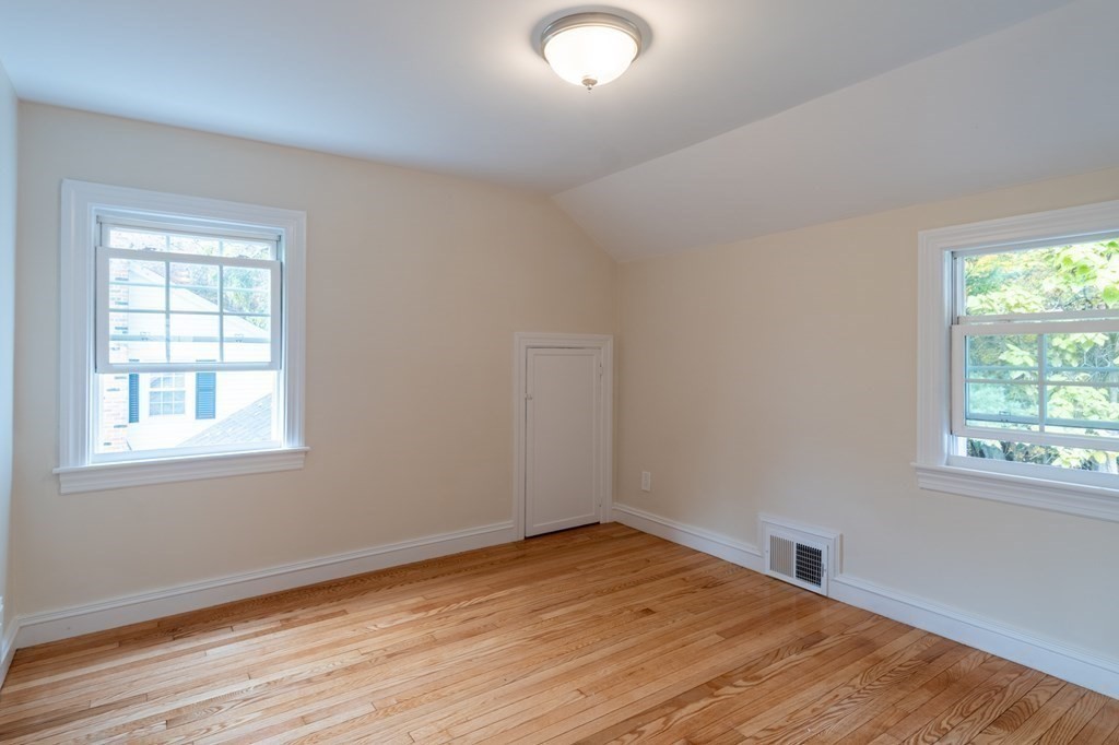 90 Hartwick Street Springfield, MA 01108 - Photo 18 of 33 an empty room with wooden floor and windows