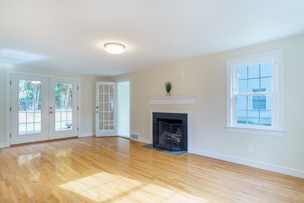 90 Hartwick Street Springfield, MA 01108 - Photo 4 of 33 a view of an empty room with a fireplace and a window