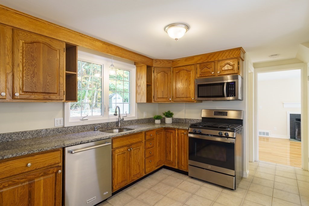 90 Hartwick Street Springfield, MA 01108 - Photo 8 of 33 a kitchen with stainless steel appliances granite countertop a stove a sink and a microwave