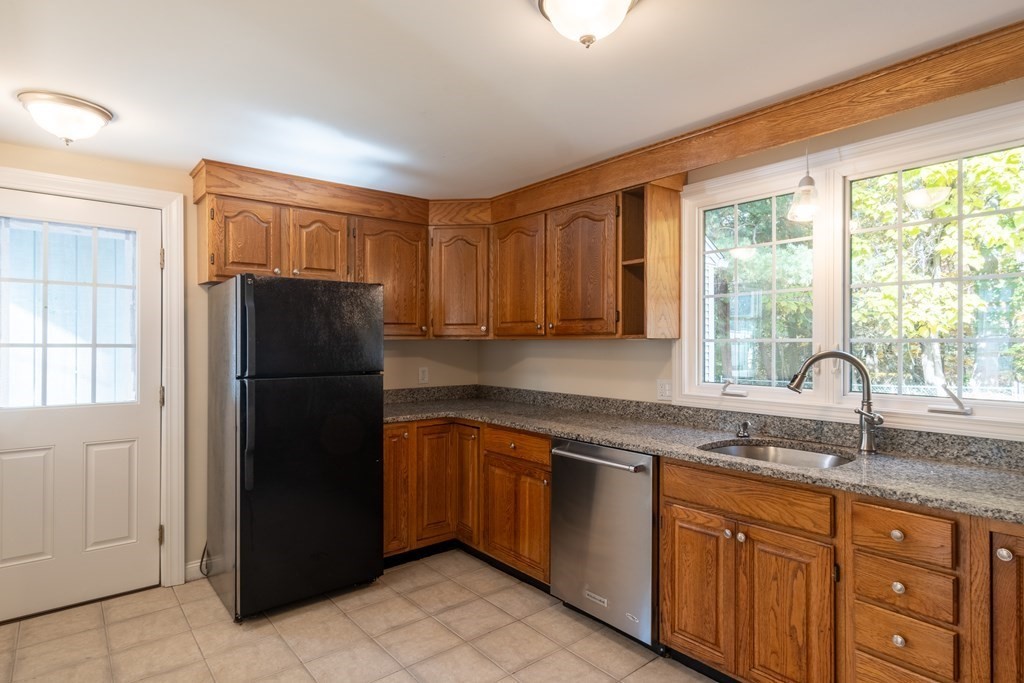 90 Hartwick Street Springfield, MA 01108 - Photo 10 of 33 a kitchen with stainless steel appliances granite countertop a refrigerator and a sink