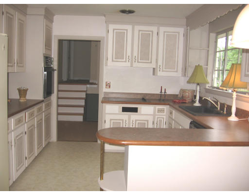 25 Linda Road Andover, MA 01810 - Photo 5 of 8 a kitchen with kitchen island a sink stove and cabinets