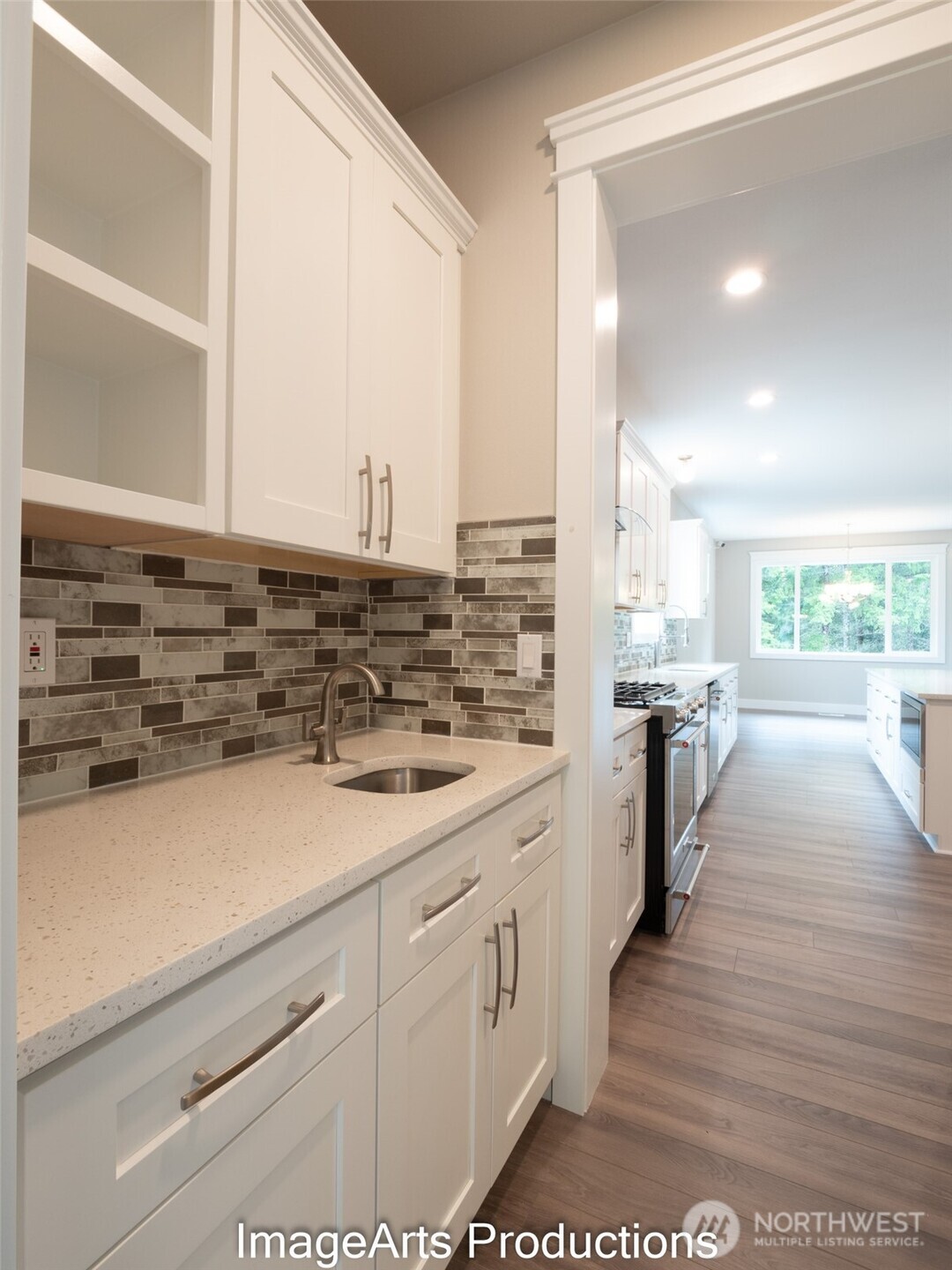 0 Herron Road Northwest Lakebay, WA 98349 - Photo 16 of 24 a view of a kitchen counter space a stove wooden floor cabinets