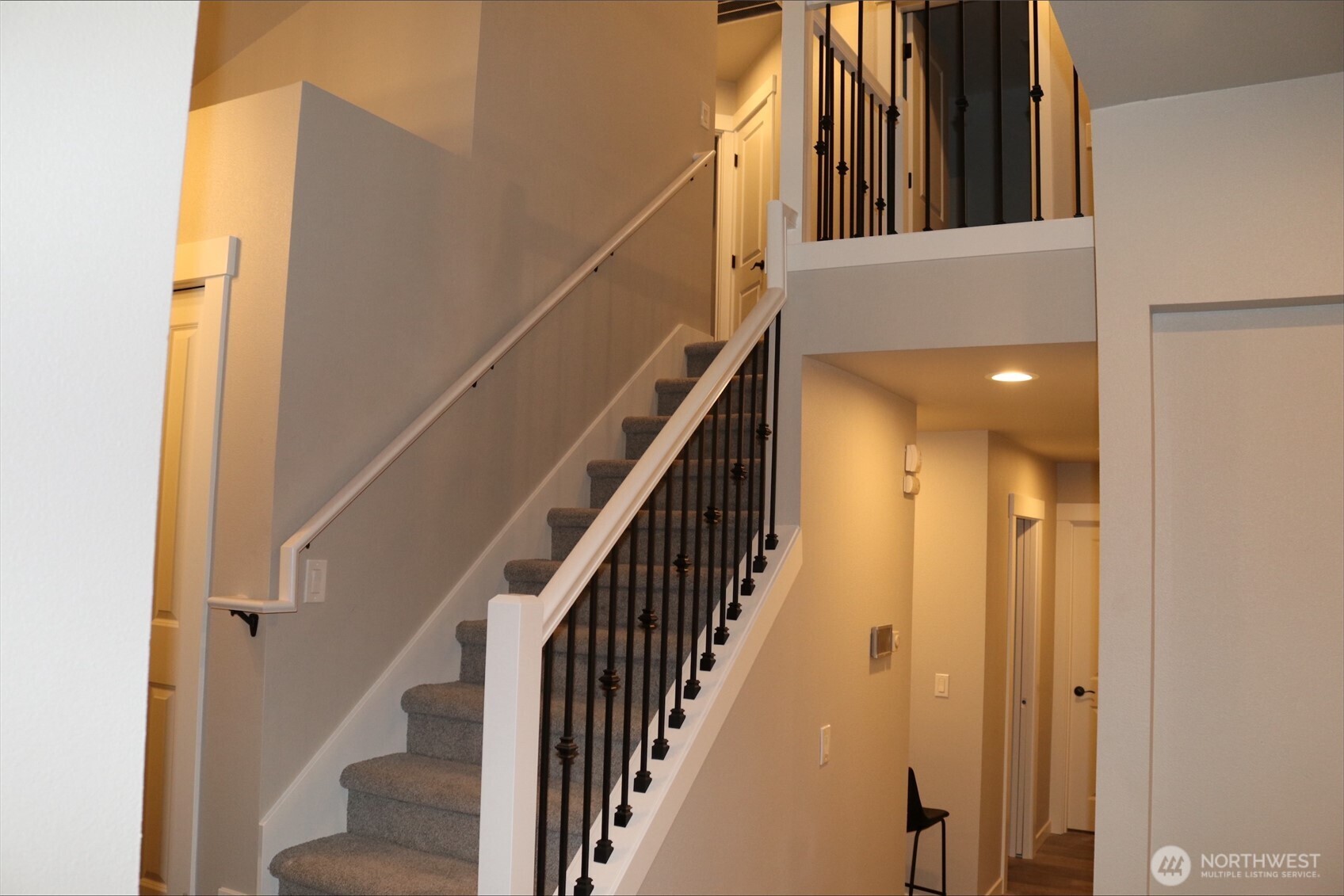 0 Herron Road Northwest Lakebay, WA 98349 - Photo 22 of 24 a view of staircase with lots of frames on wall and windows