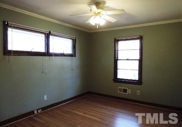 3005 Hickory Road Raleigh, NC 27616 - Photo 9 of 25 a view of an empty room with a window and wooden floor