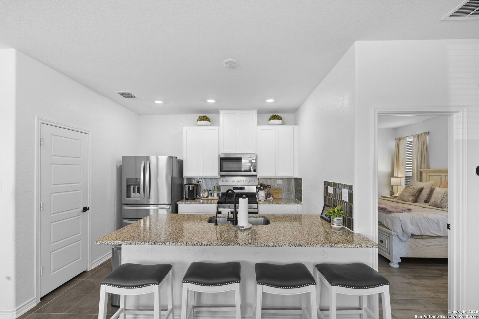 4931 Park Marion, TX 78124 - Photo 7 of 20 a kitchen with stainless steel appliances kitchen island granite countertop a dining table chairs and granite counter tops