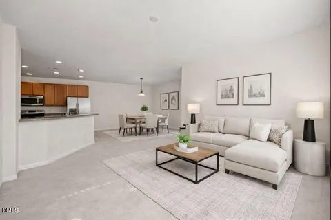a living room with furniture and kitchen view