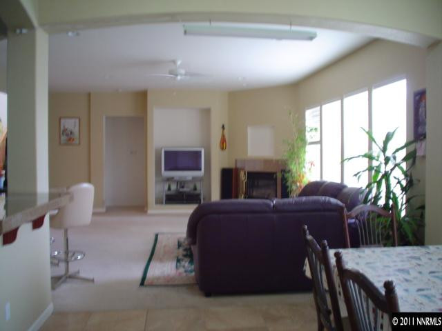 10140 Canyon Country Road Reno, NV 89521 - Photo 8 of 13 a living room with furniture a fireplace and a large window