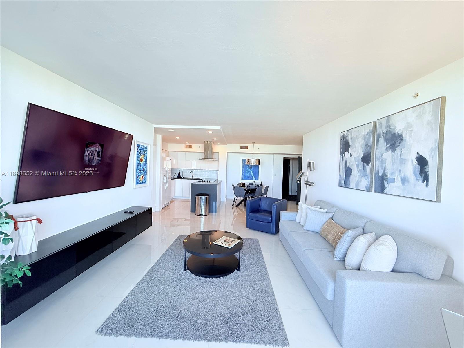 90 Alton Road, Unit 909 Miami Beach, FL 33139 - Photo 11 of 37 a living room with furniture and a couch