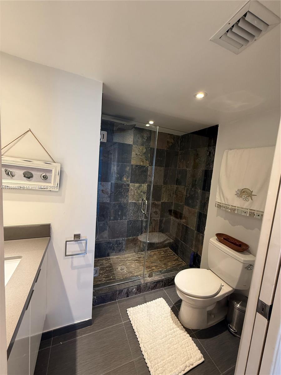 90 Alton Road, Unit 909 Miami Beach, FL 33139 - Photo 12 of 37 a bathroom with a toilet and a shower