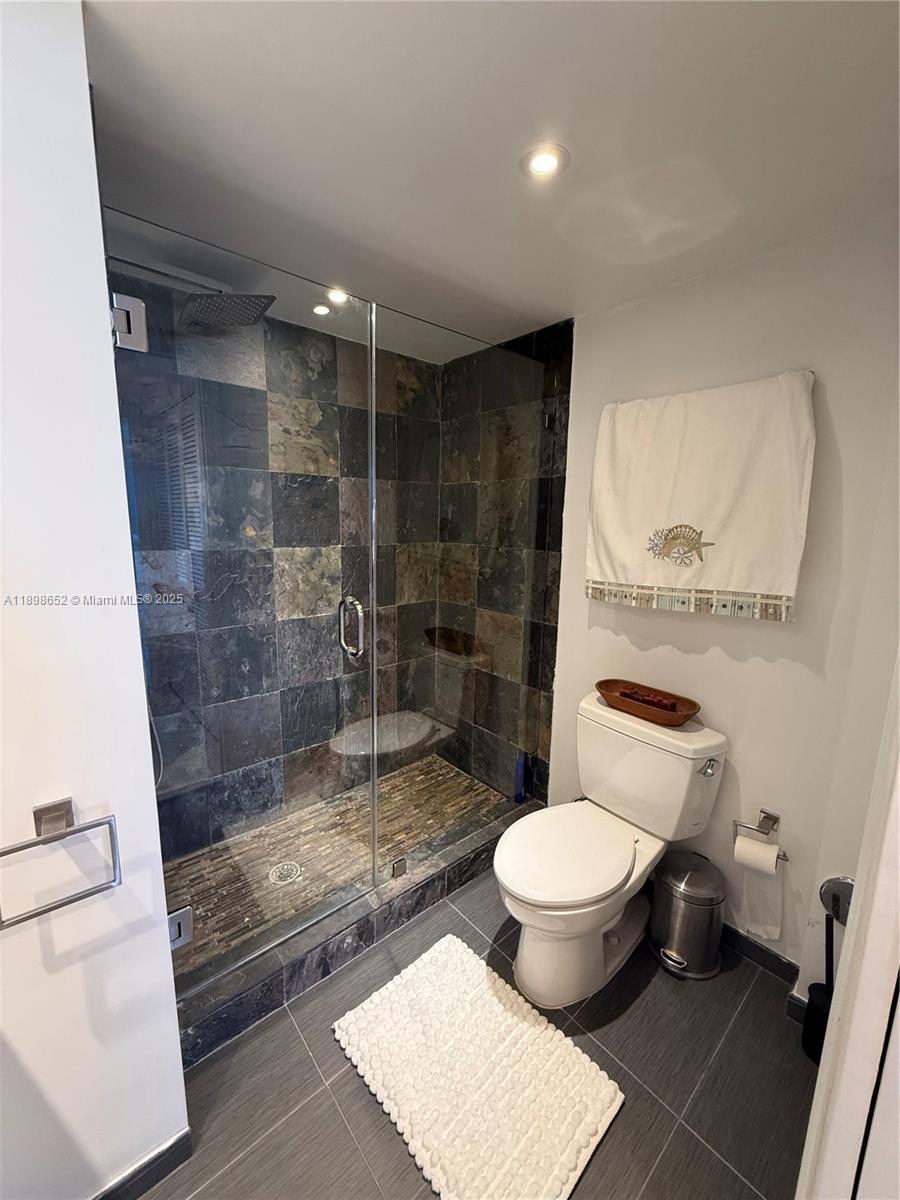 90 Alton Road, Unit 909 Miami Beach, FL 33139 - Photo 13 of 37 a bathroom with a toilet and a shower