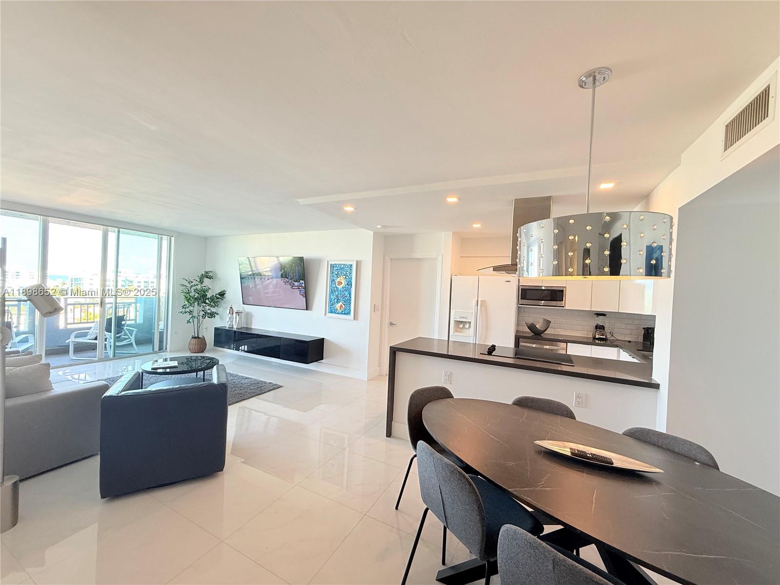 90 Alton Road, Unit 909 Miami Beach, FL 33139 - Photo 18 of 37 a living room with furniture and a table